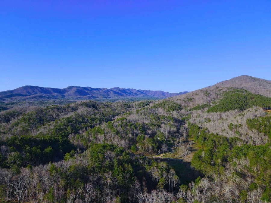 Forested ridges and mountains seen from above in clear weather