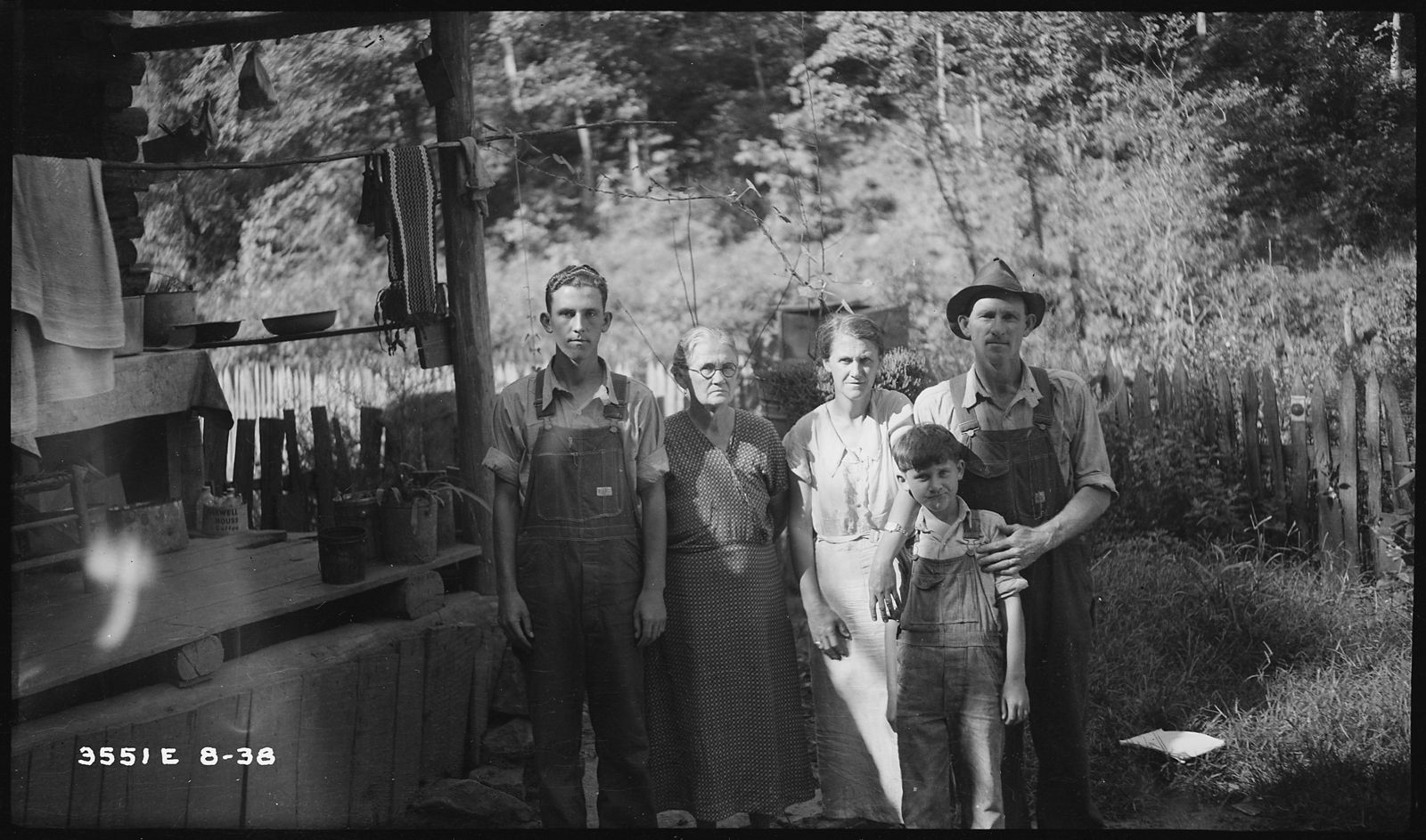 The J.L. Morrow family standing in front of their log porch