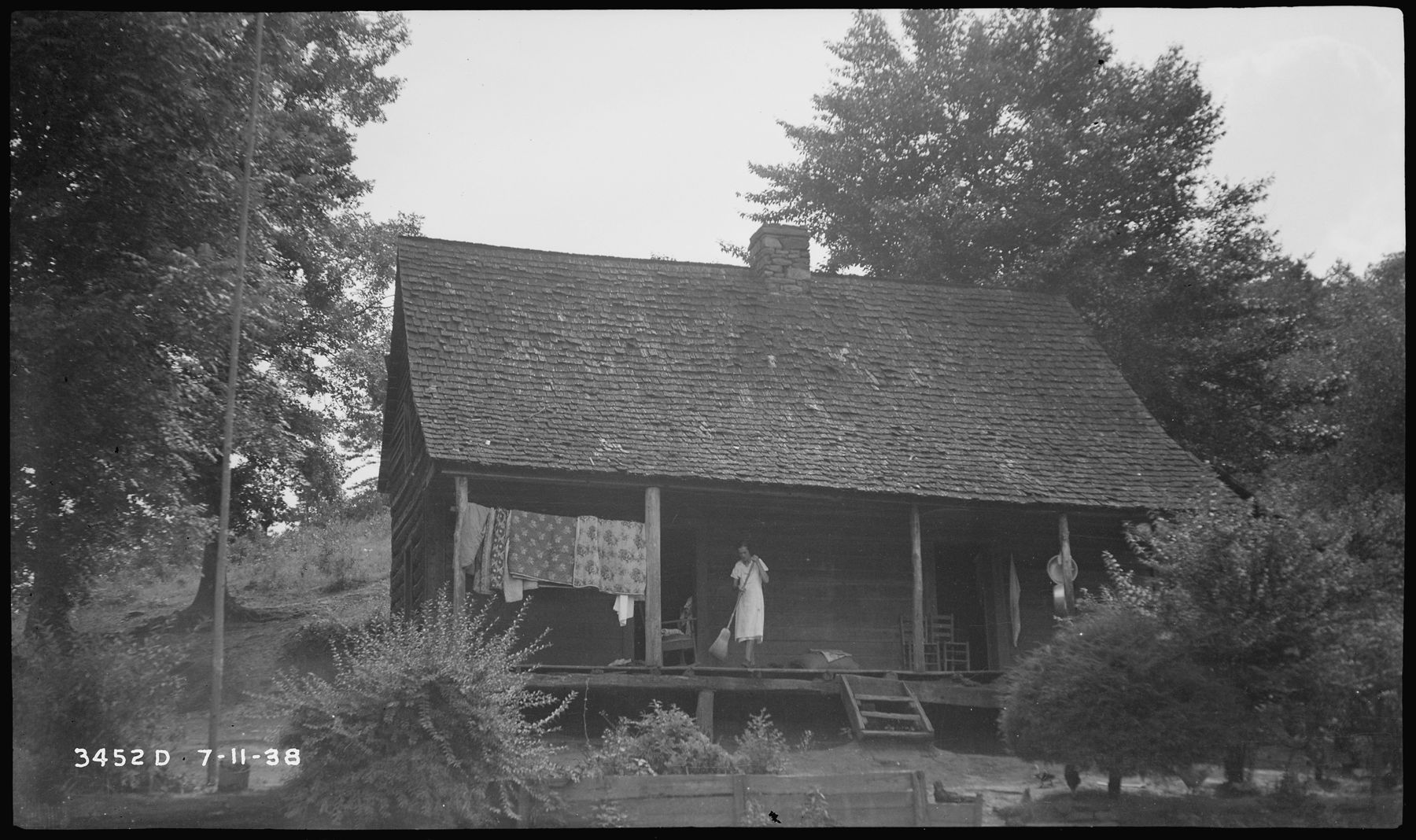 Quilts airing on the porch of the Columbus Thompson home, 1938