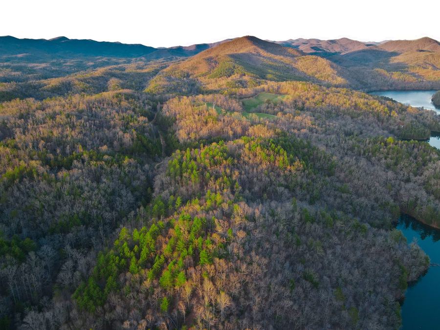 Aerial view of autumn-colored ridges with the lake at the edge of the frame