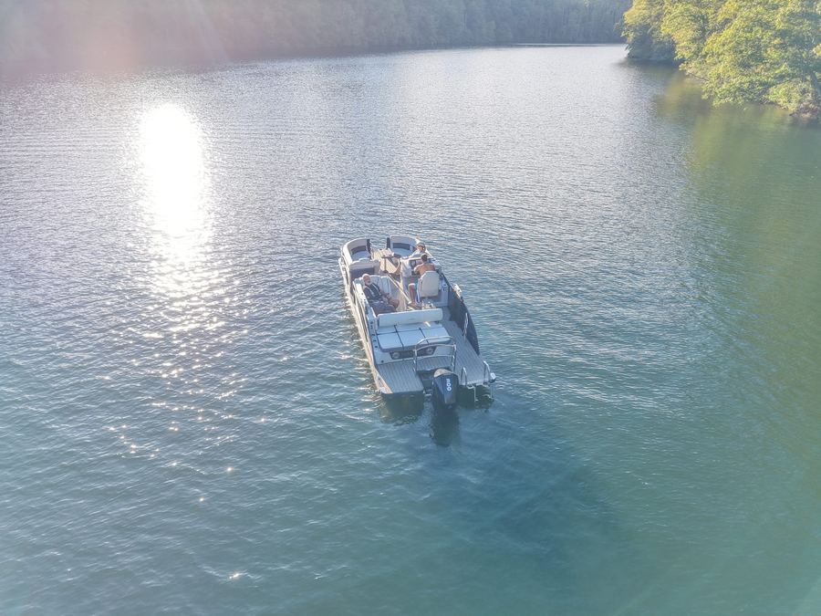 A small boat on bright open water, seen from above
